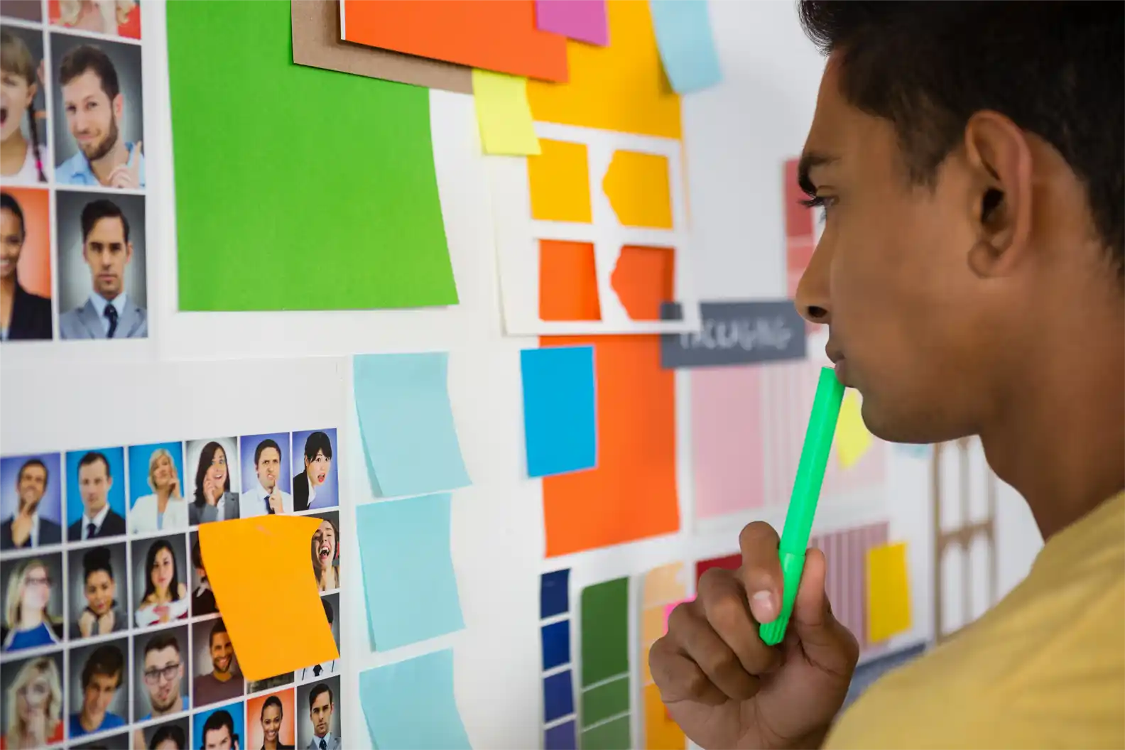 thoughtful-man-looking-at-sticky-notes