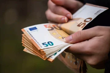 closeup-female-hands-counting-euro-banknotes-world-money-inflation-economy-concept