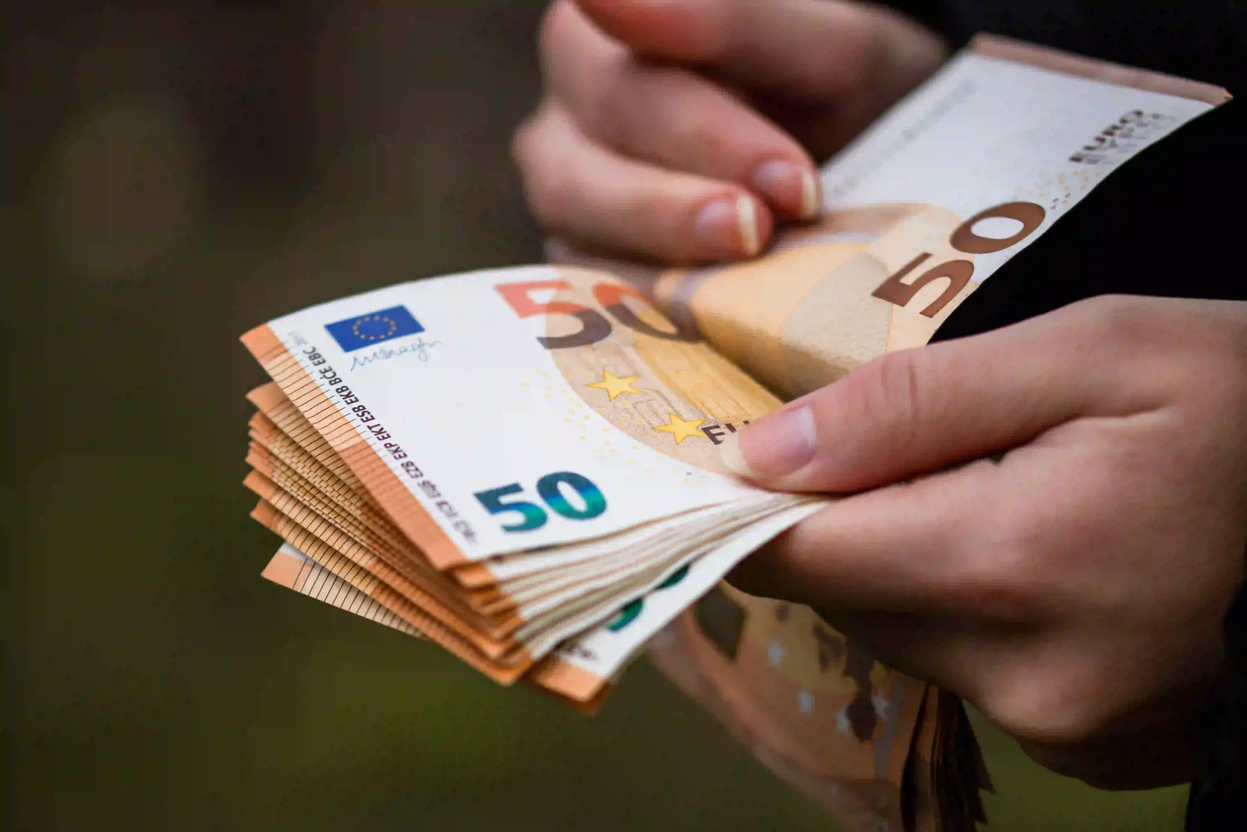 closeup-female-hands-counting-euro-banknotes-world-money-inflation-economy-concept