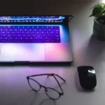 laptop-with-graphs-statistics-glasses-table